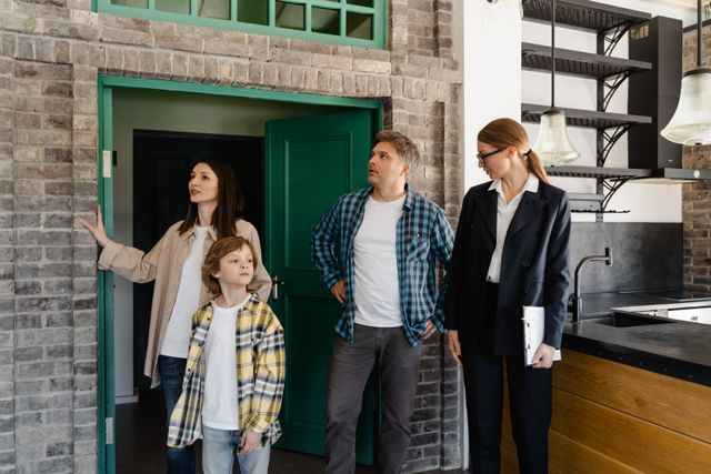 Family exploring potential new home guided by a real estate agent