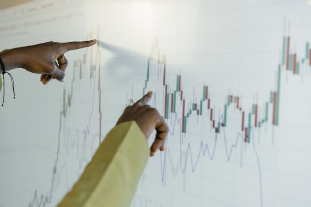 Fingers Pointing the Graph on Screen