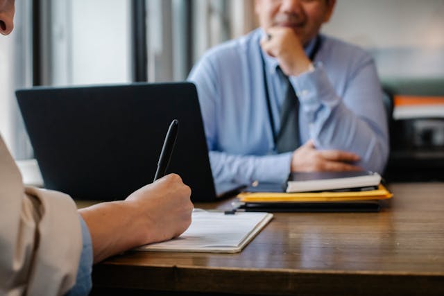 person writing during interview